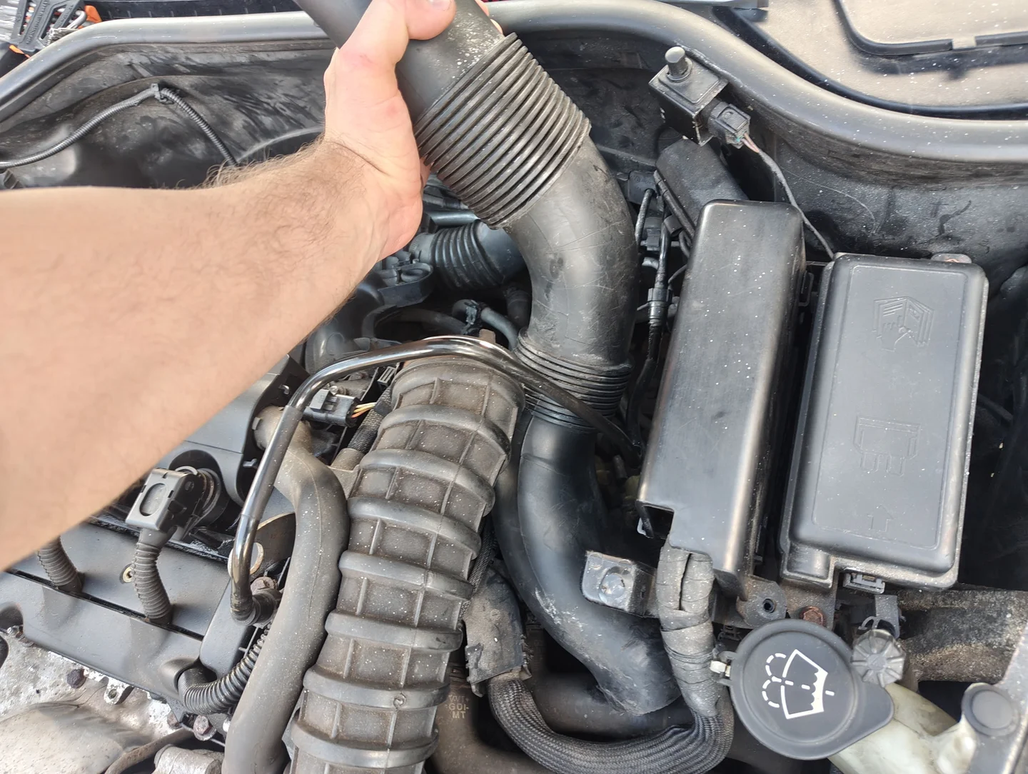 Air intake duct being pulled from the engine bay