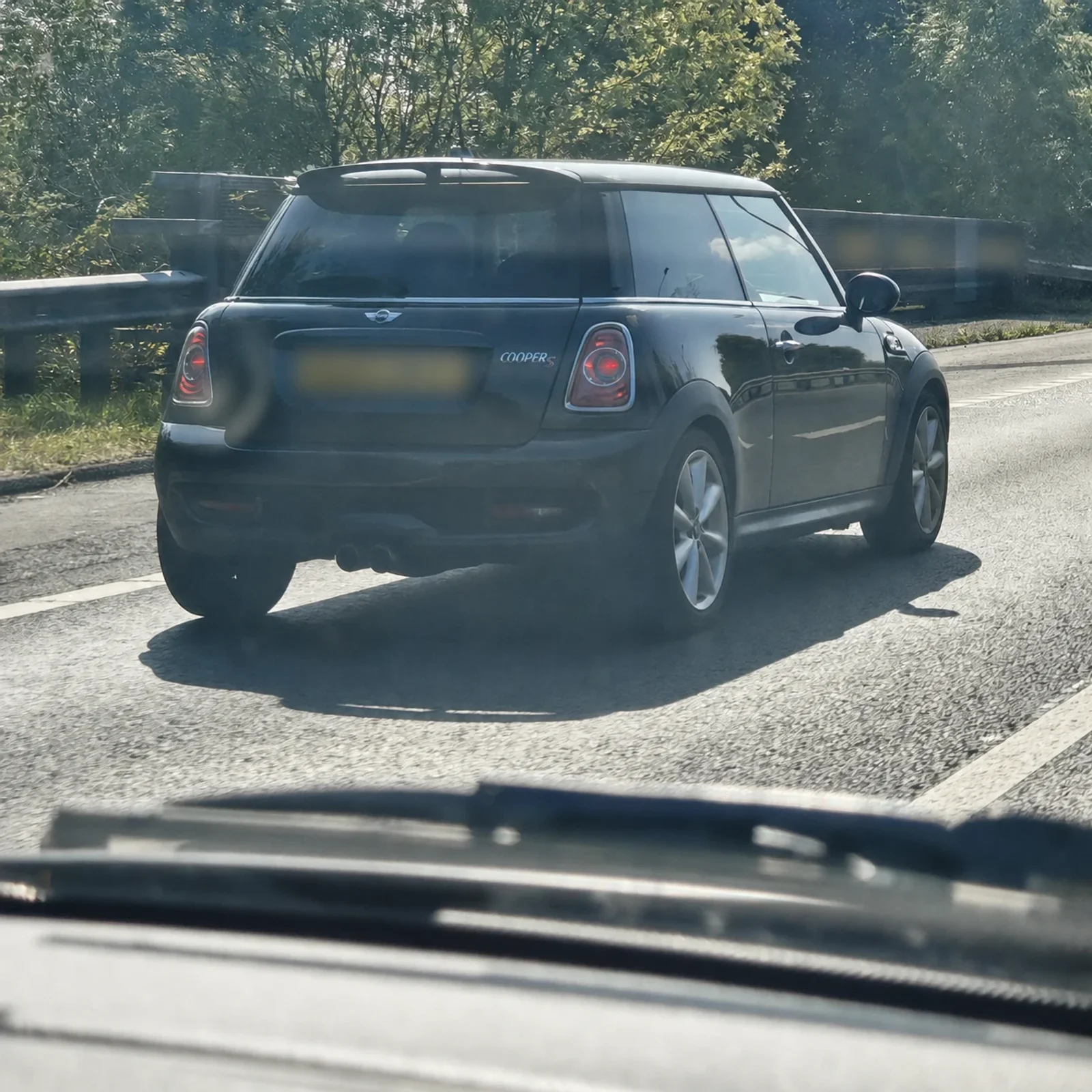 Black MINI R56 Cooper S driving on the road