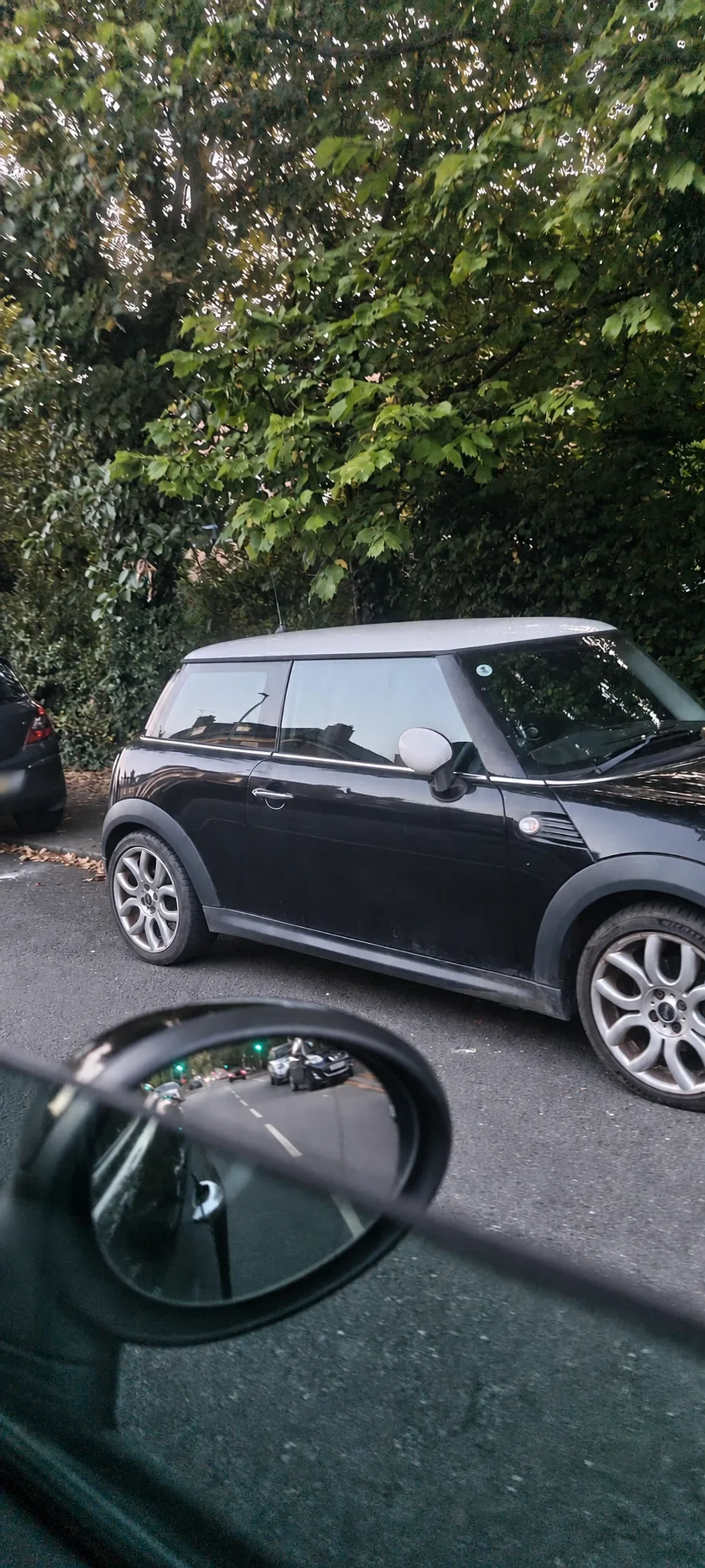 Black MINI R56 seen through a car window