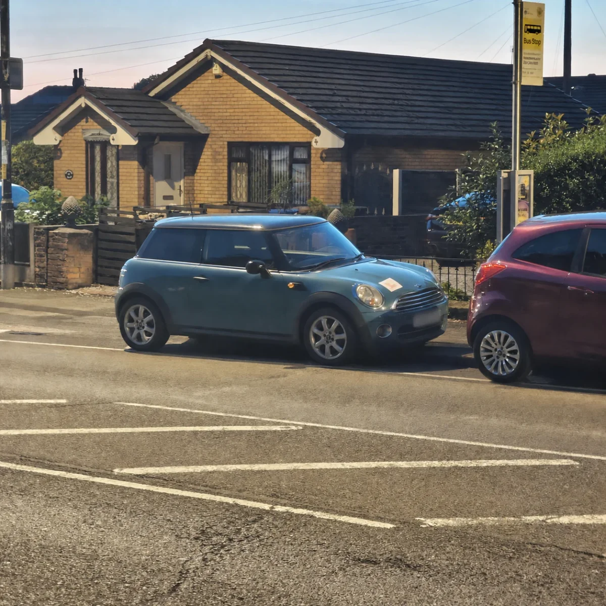 Blue MINI R56 parked beside a residential road