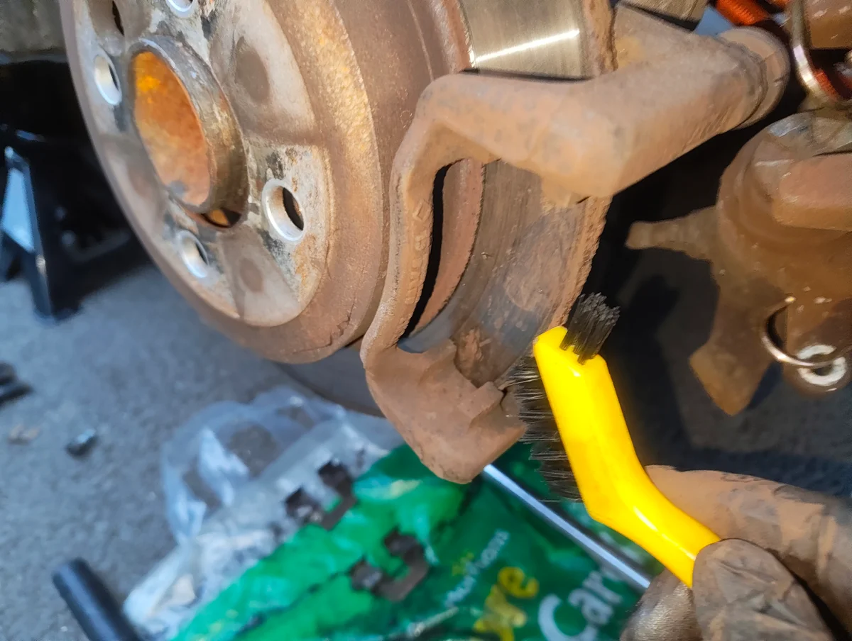 Brushing rear brake caliper bracket