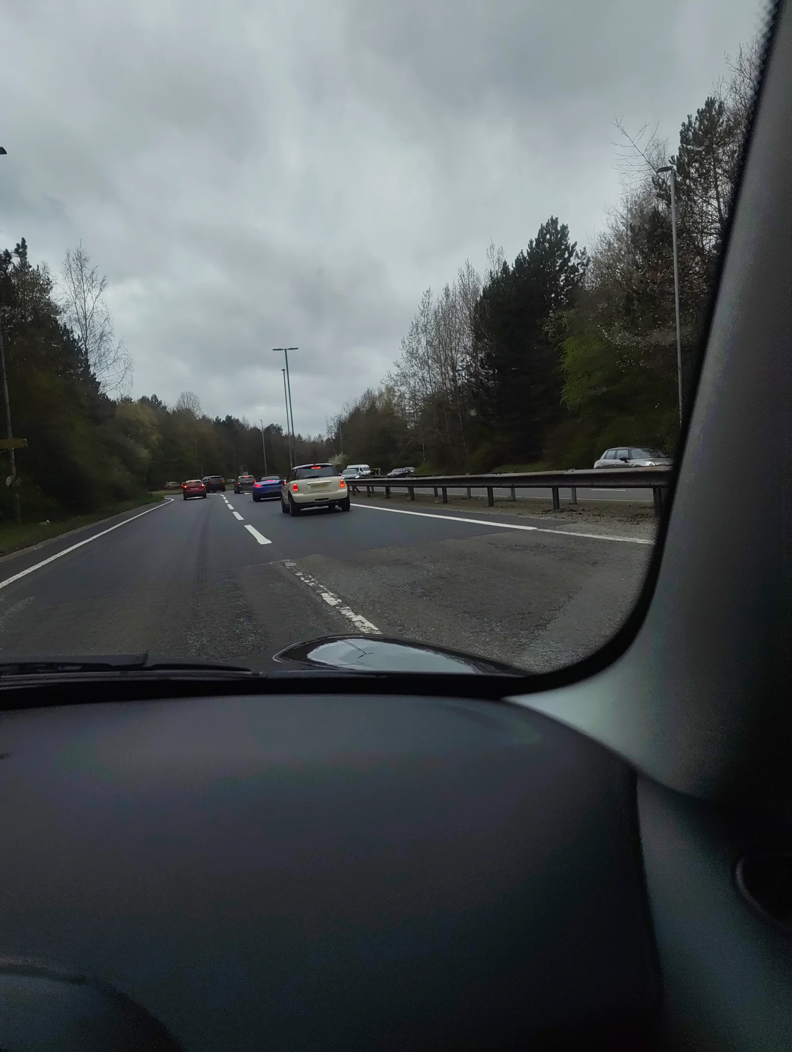 Cream MINI R56 driving in motorway traffic