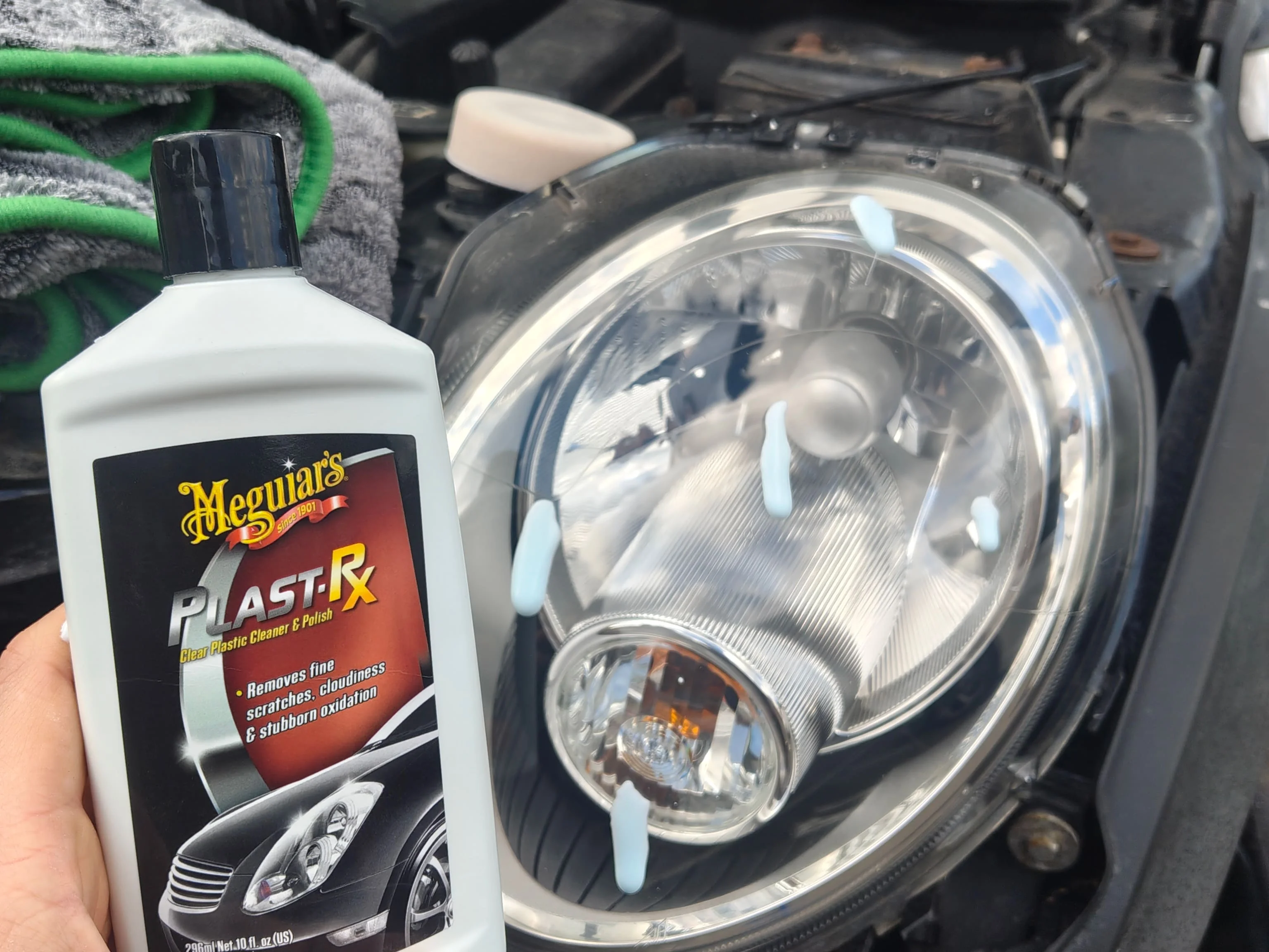 Dots of Meguiar's Plast-Rx on a headlight