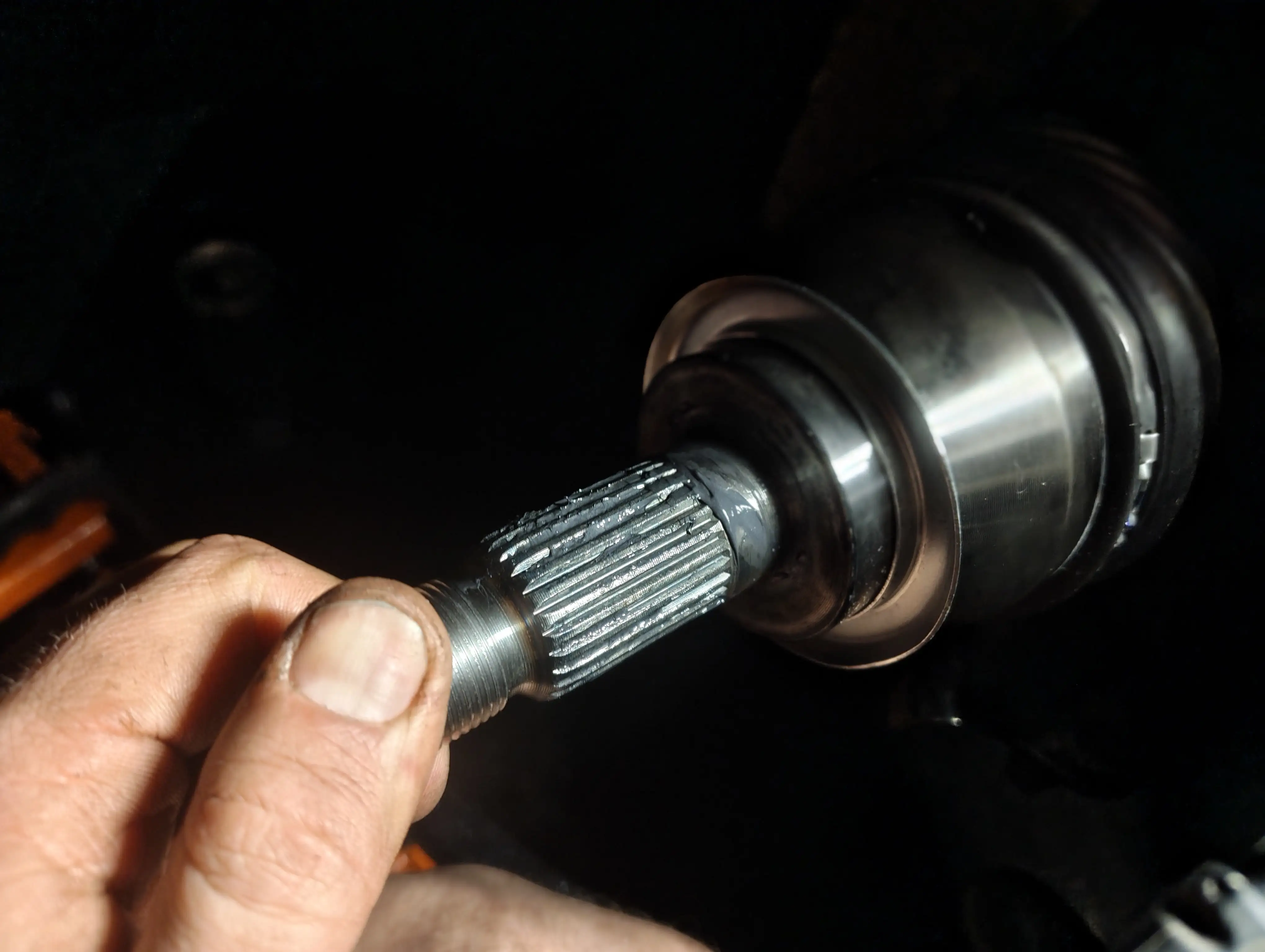 Greasing the front passenger-side driveshaft spline with CV Lith-Moly grease