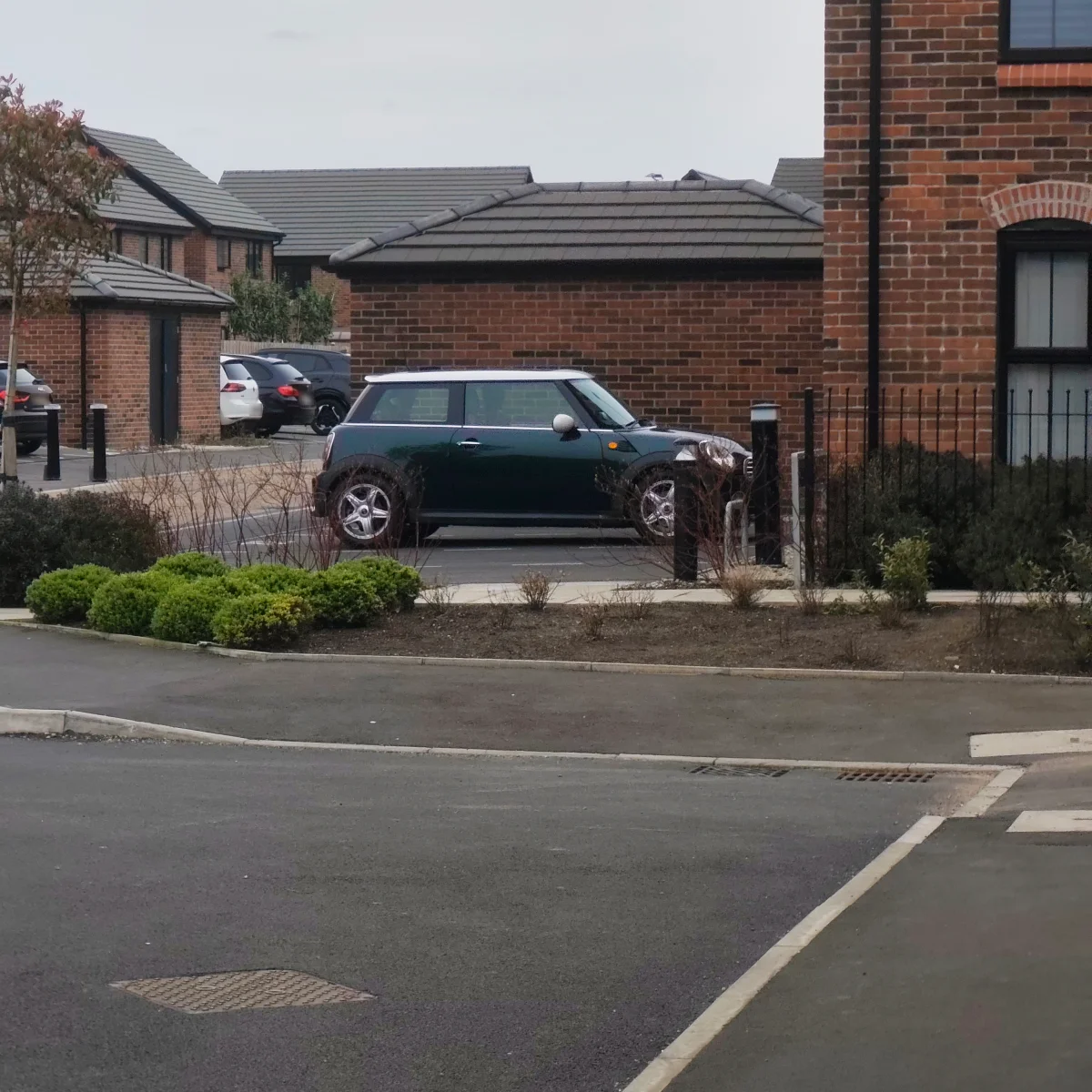 Green MINI R56 parked on a housing estate