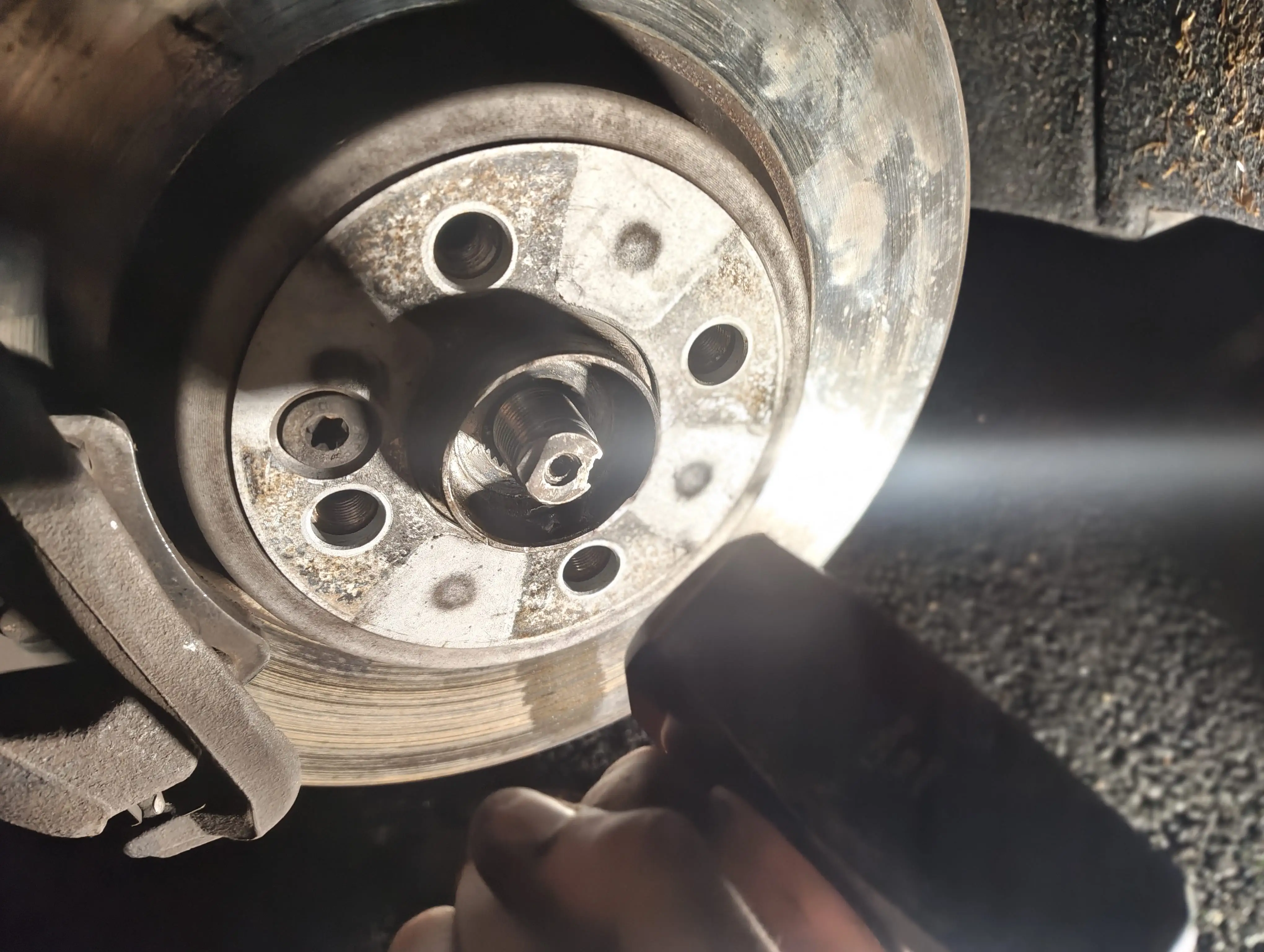 Hammering the front passenger-side driveshaft spline with a club hammer