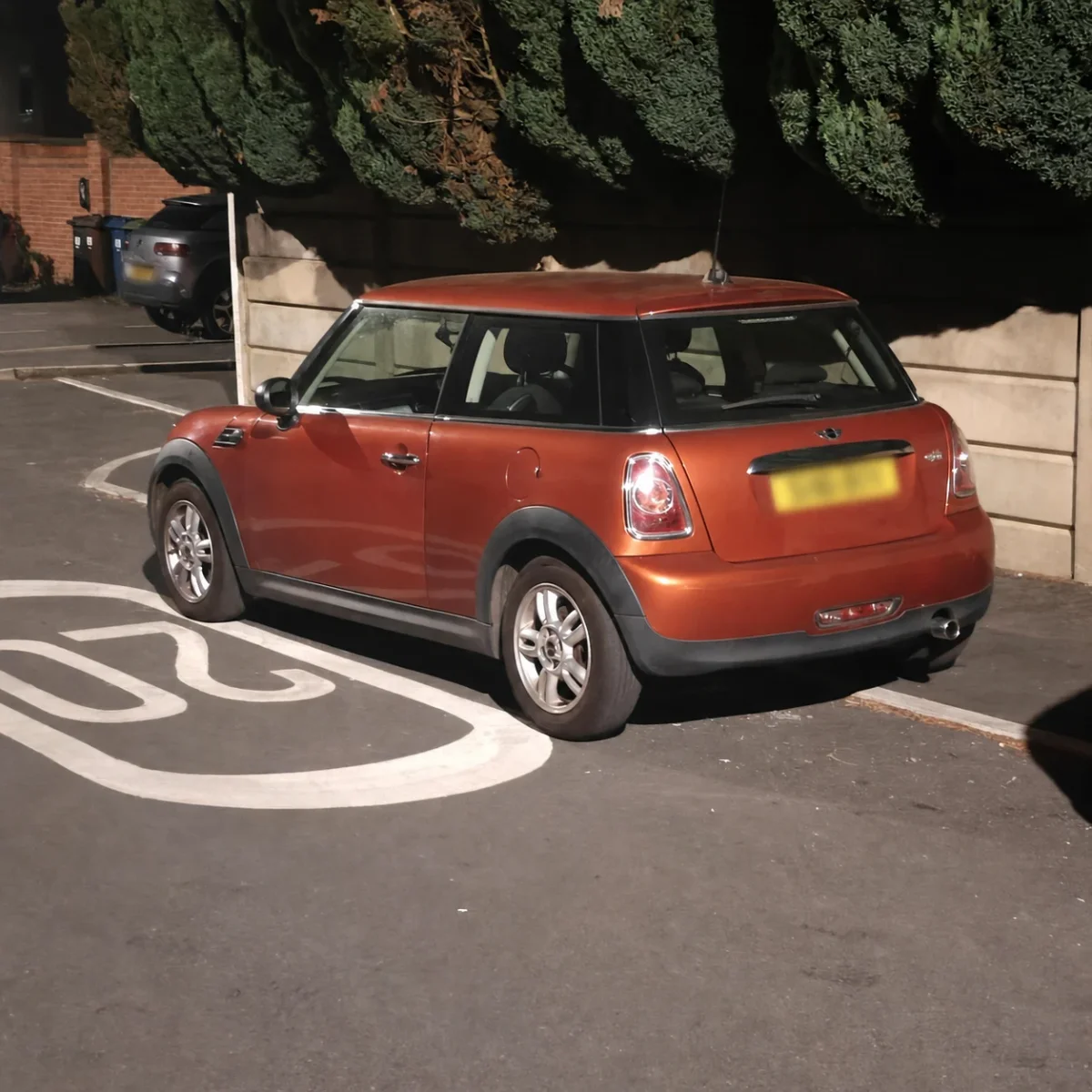 Orange MINI R56 parked at night