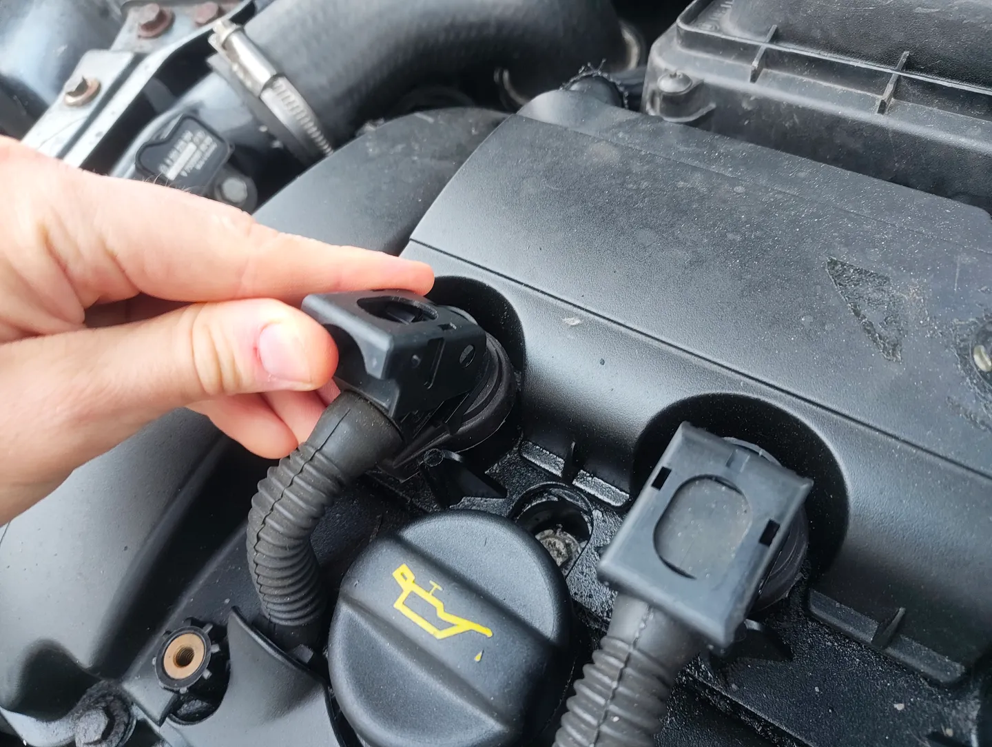 Partially lifted ignition coil fastener