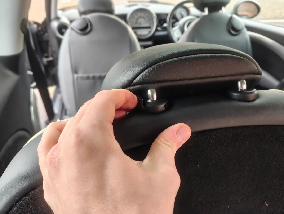 Pressing rear seat head rest button