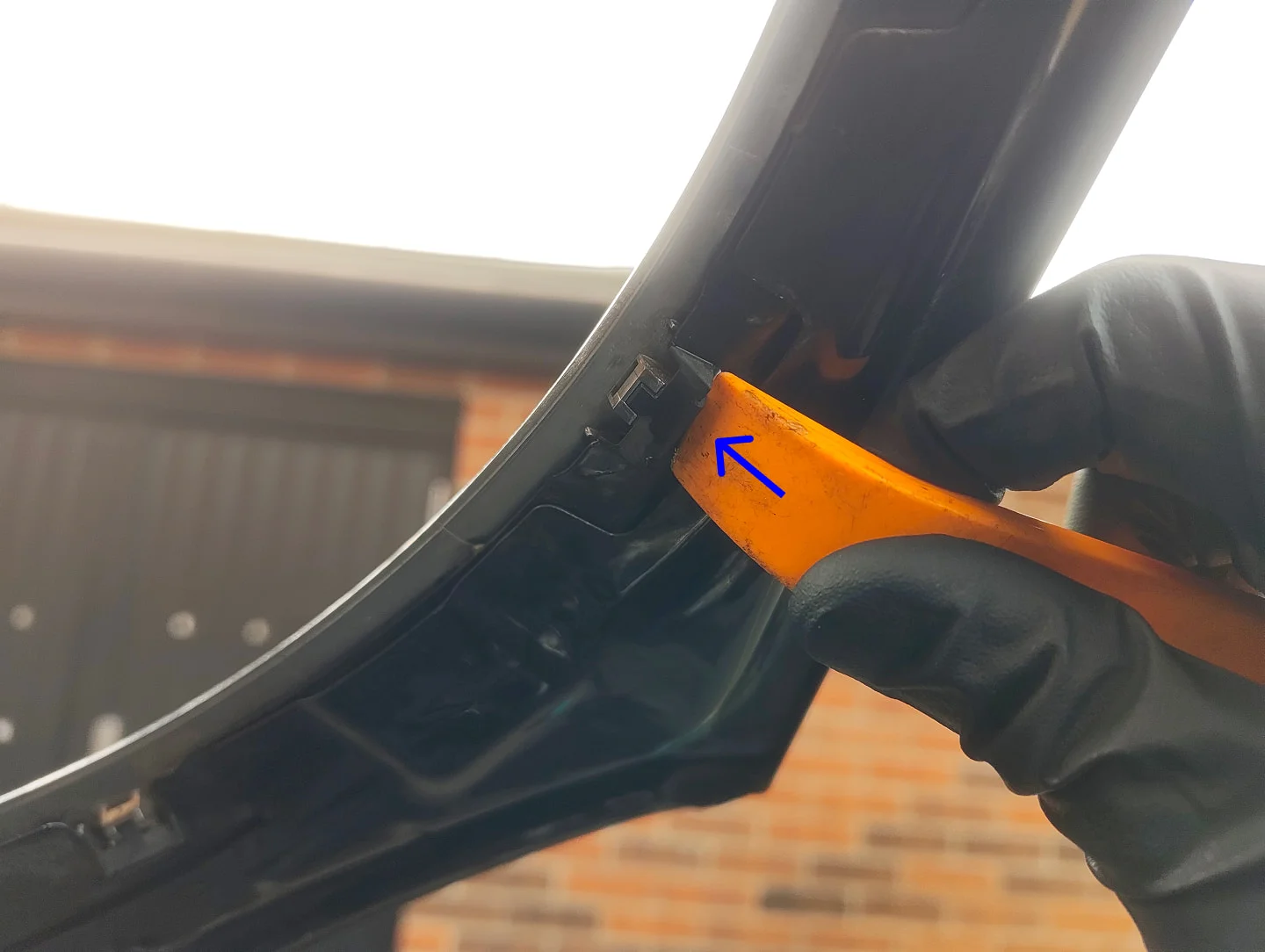 Prying headlight trim clip