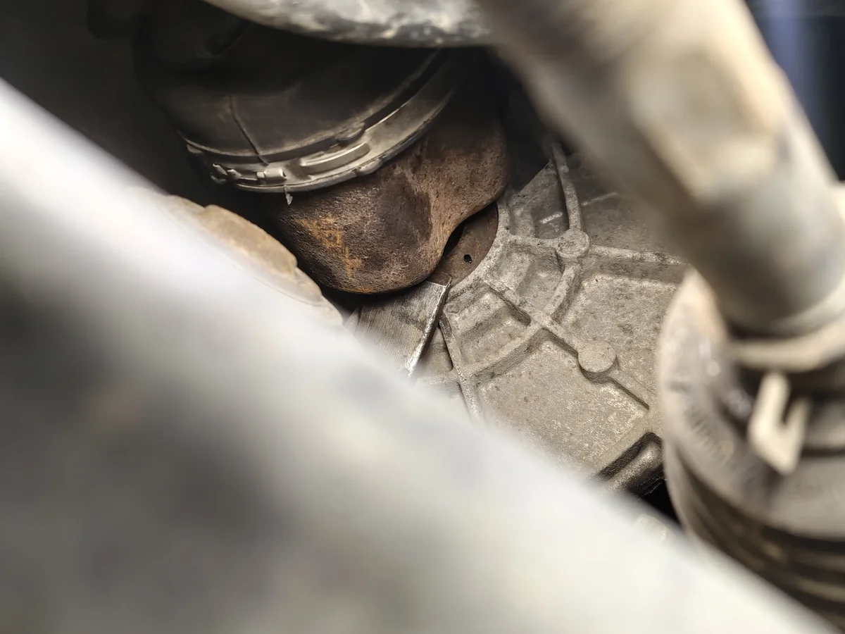 Prying the front passenger-side driveshaft inner joint