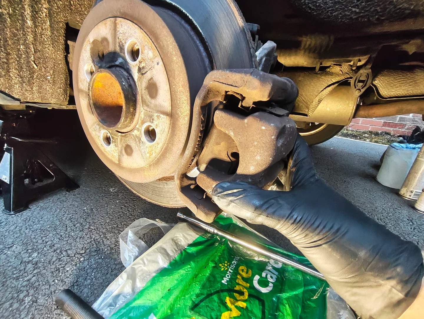 Pulling rear brake caliper away