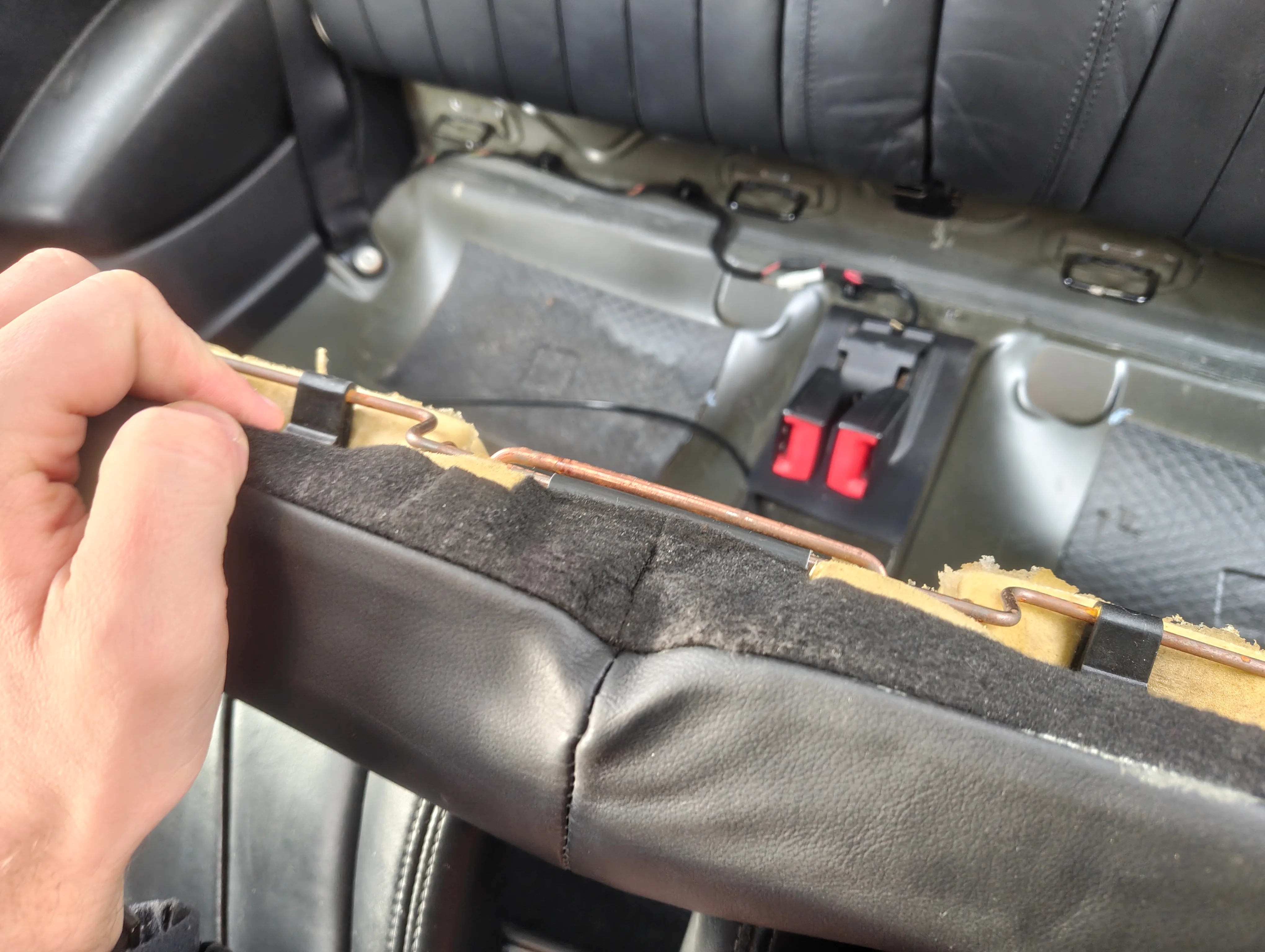 Rear seat bottom hook