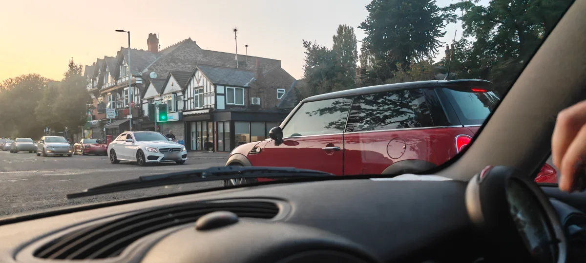 Red MINI R56 in evening city traffic