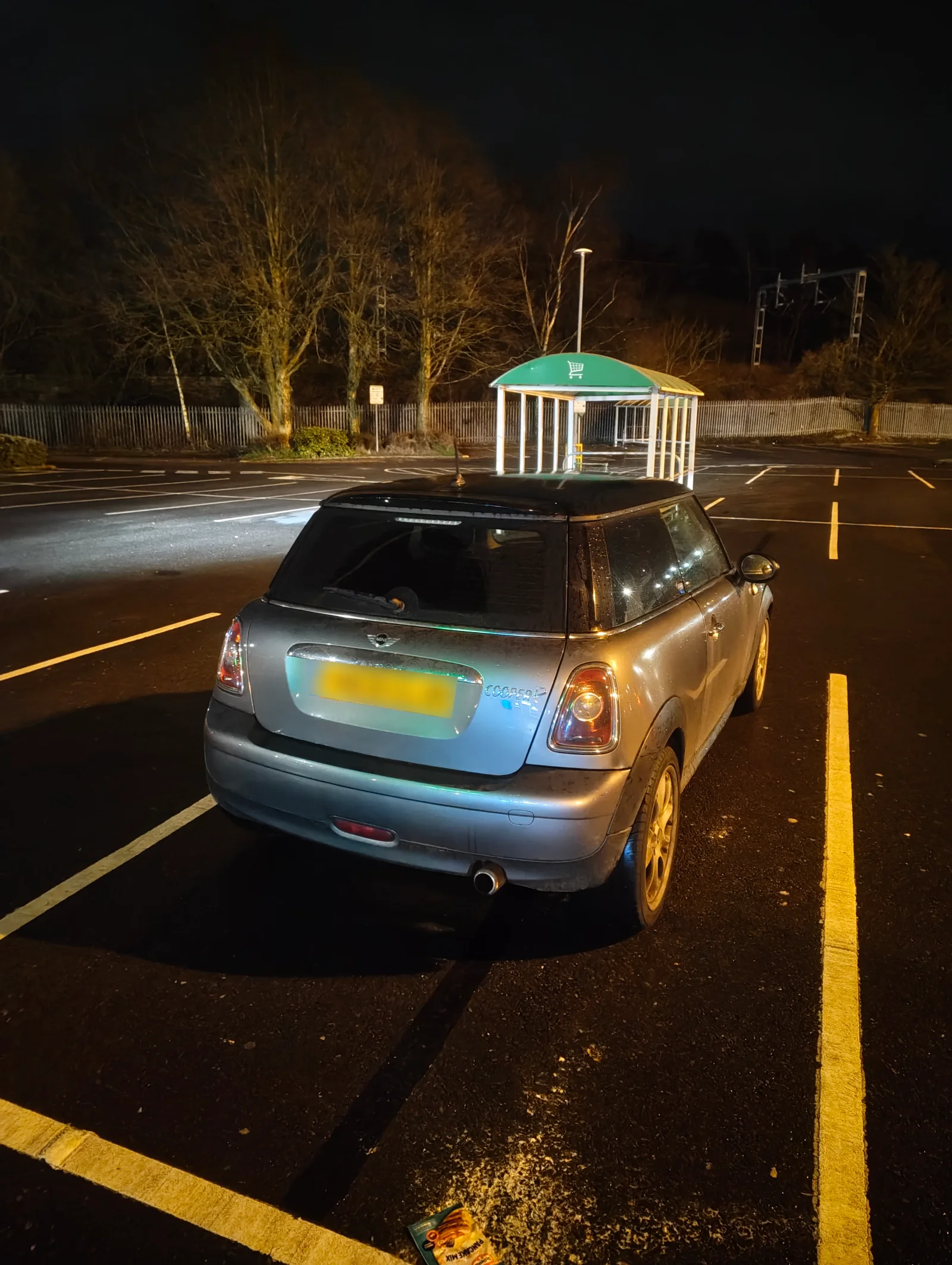 Silver MINI R56 Cooper in an empty car park at night