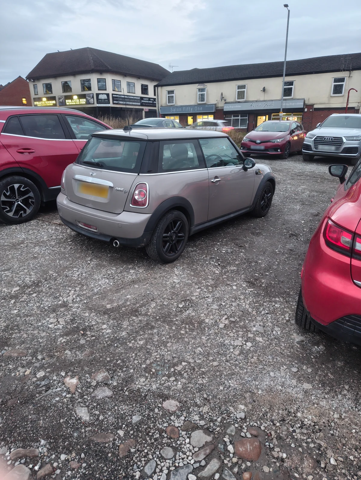 Silver MINI R56 One D in a shopping car park