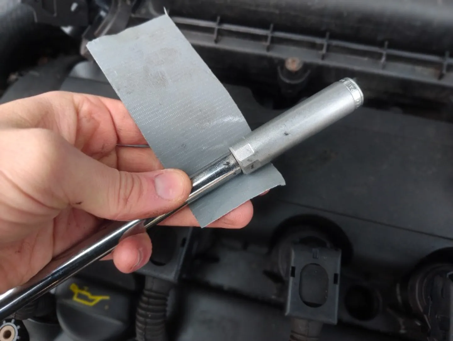 Taping spark plug socket to extension