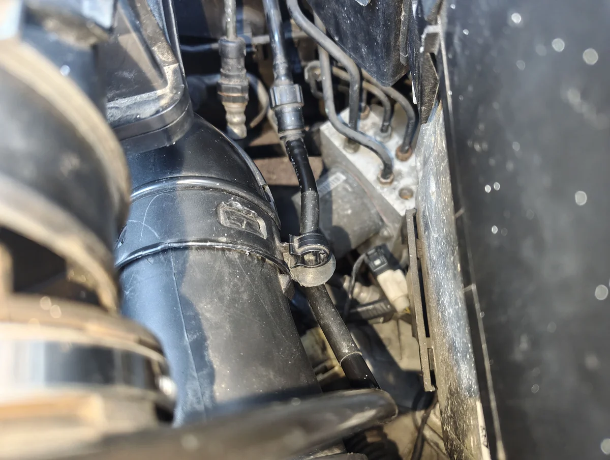 Unclipped vacuum line from air intake duct