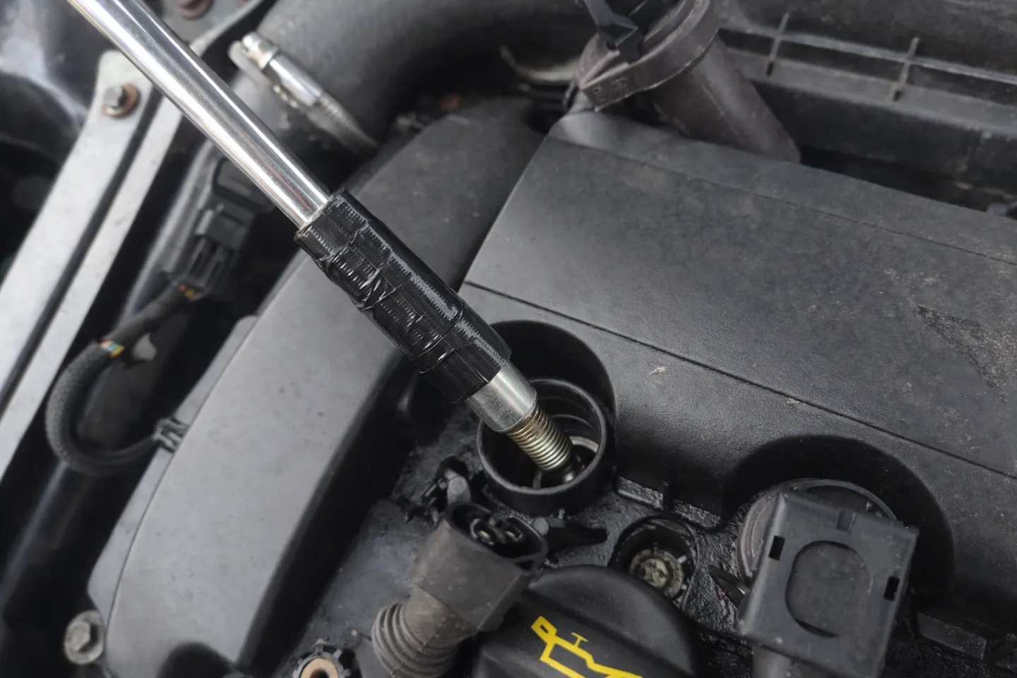 Unscrewed spark plug inside spark plug socket