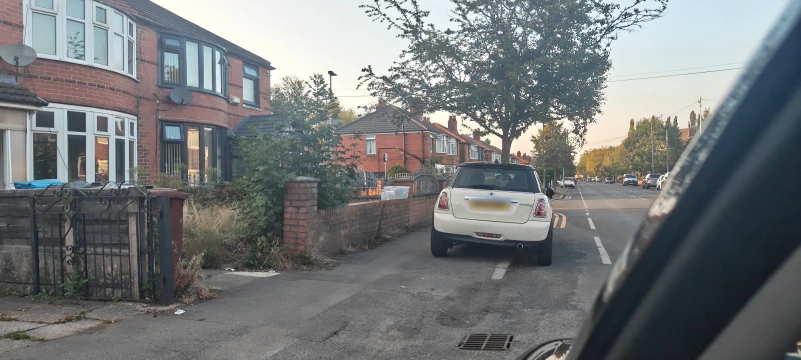 White MINI R56 parked on a residential street