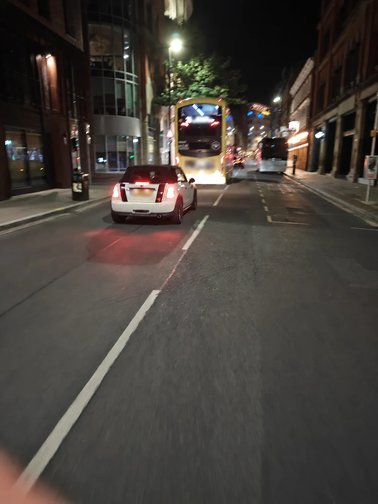 White MINI R56 driving through the city at night