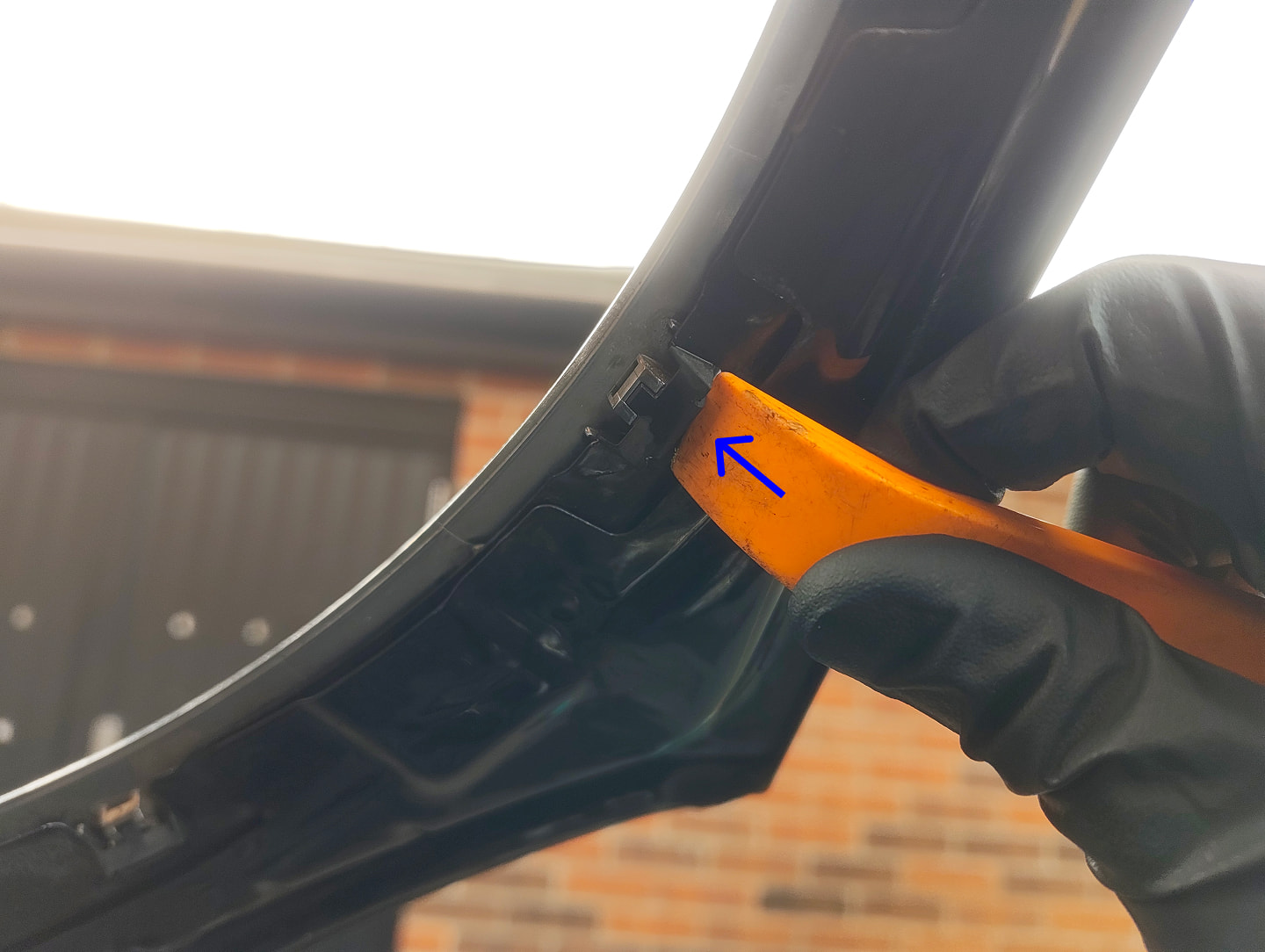 Prying headlight trim clip