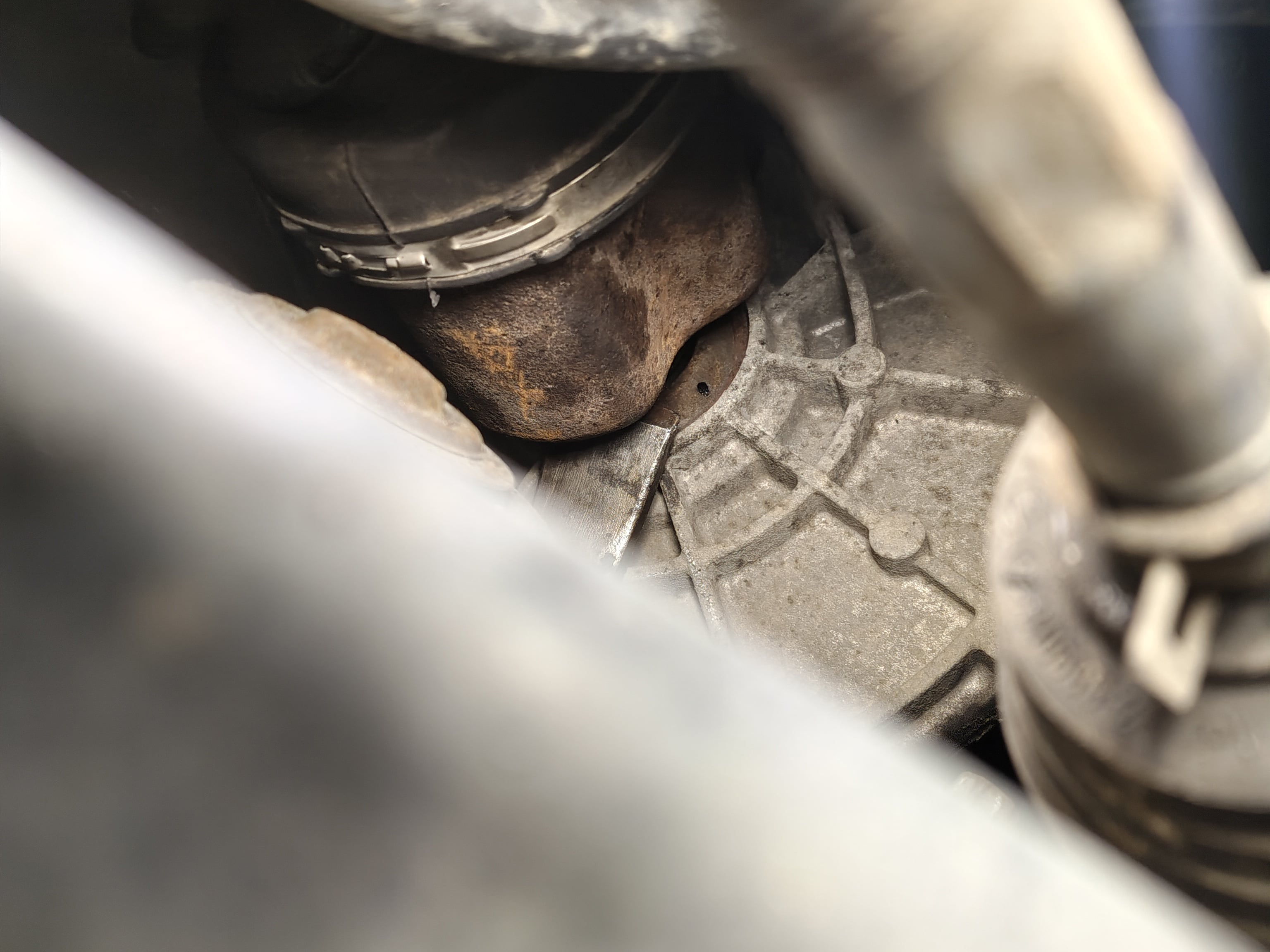 Prying the front passenger-side driveshaft inner joint