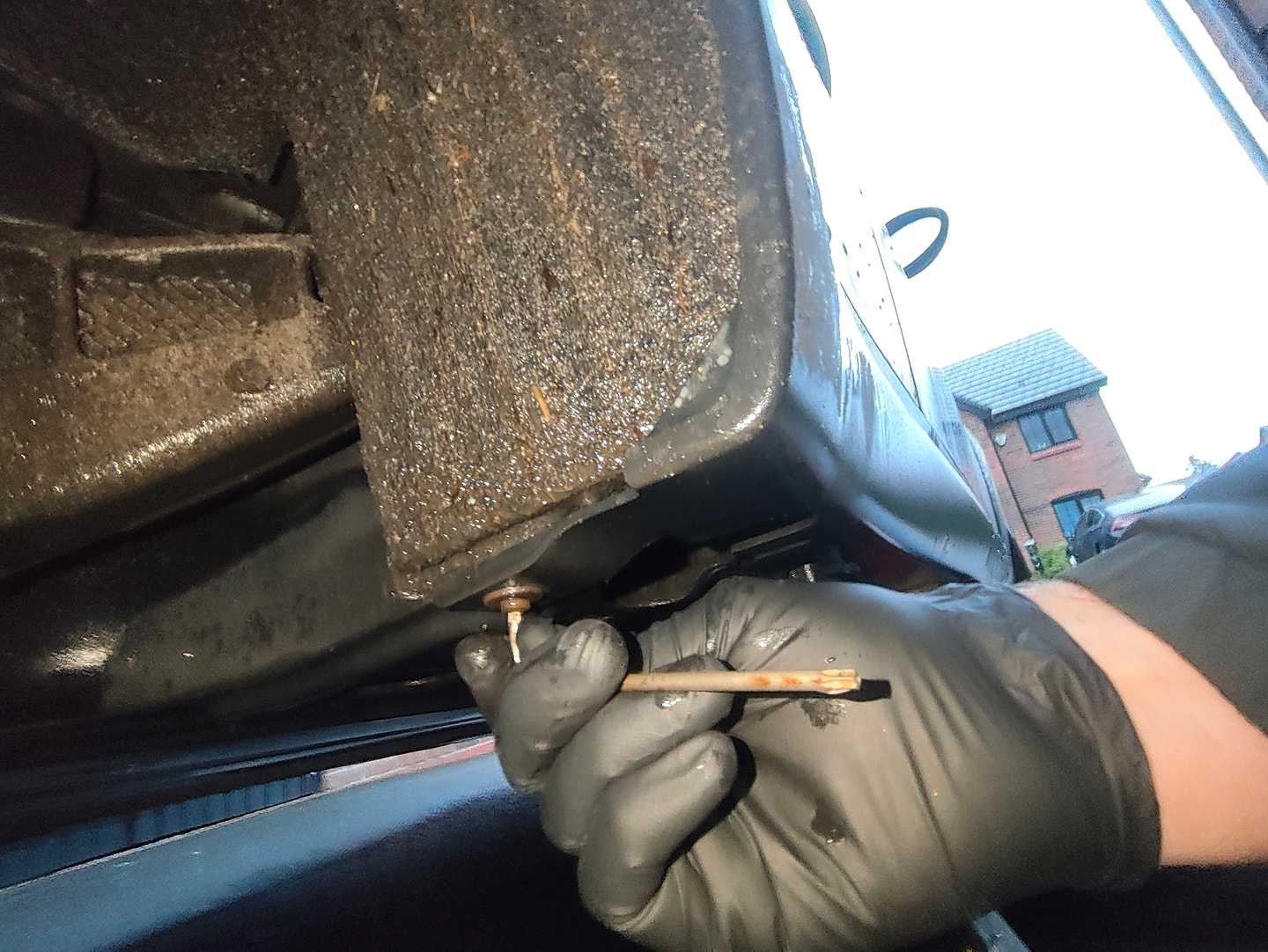 Unscrewing wheel well carpet torx screw